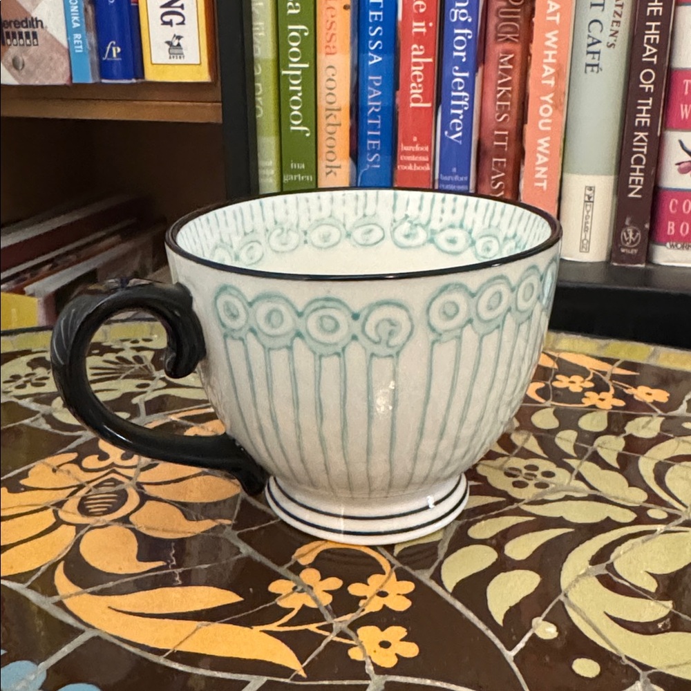 Elegant Black and White Teacup with Blue Accents